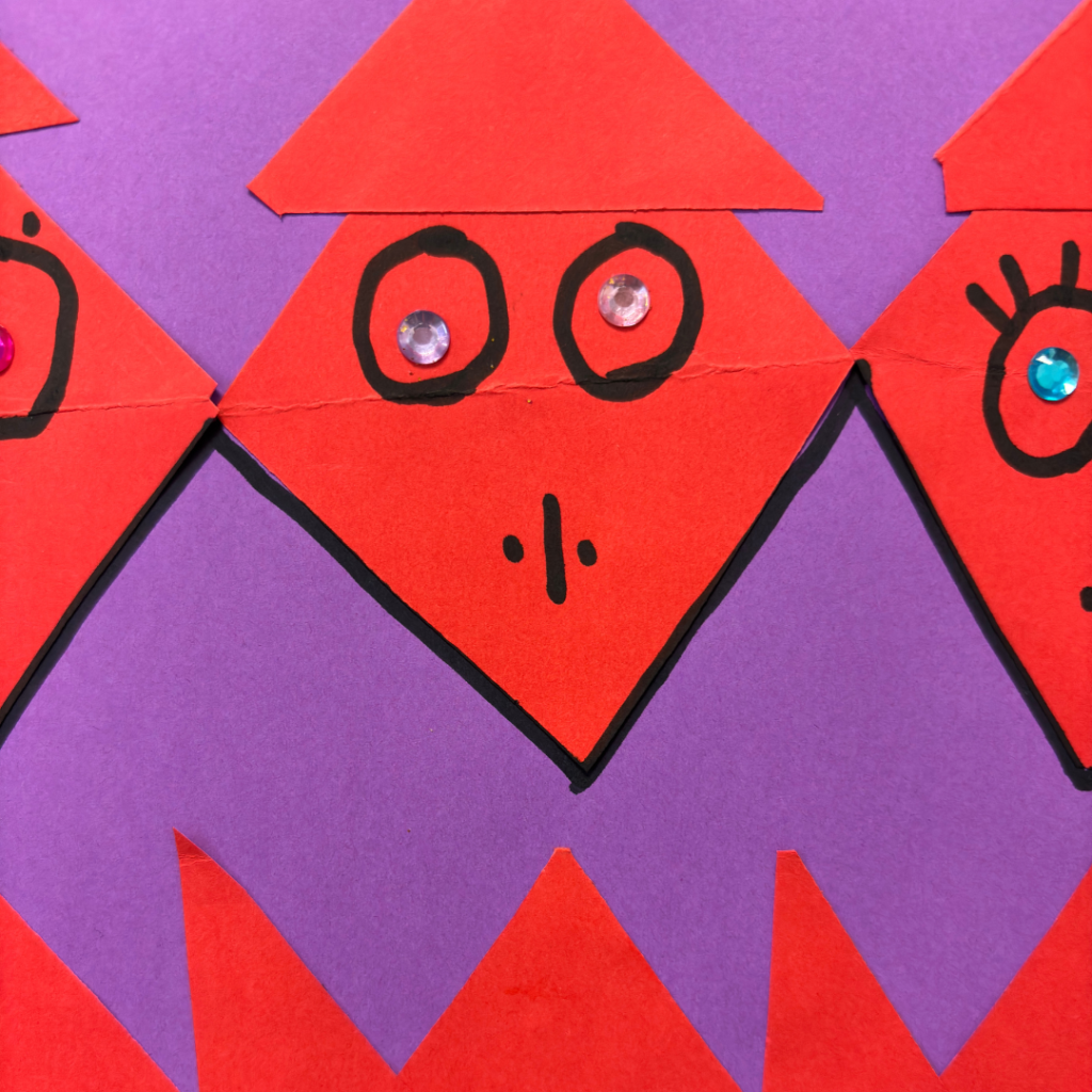 Triangle faces cut out and outlined on a solid paper background