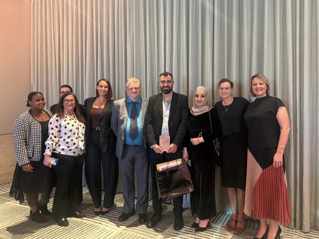 Salah and his partner with community plus staff